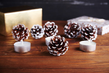 Christmas background with christmas decorations: pine cone and candels