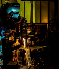 MIG welder uses torch to make sparks during manufacture of metal equipment.