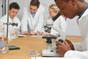Male Pupil Using Microscope In Science Class - obrazy, fototapety, plakaty
