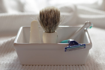 Shaving brush and razor in soap dish