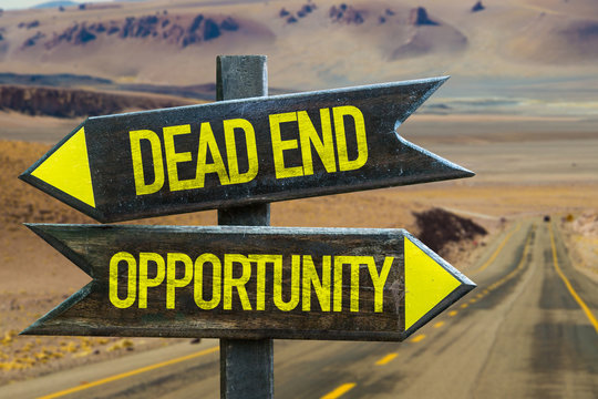 Dead End - Opportunity signpost in a desert road background