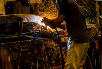 MIG welder uses torch to make sparks during manufacture of metal equipment.