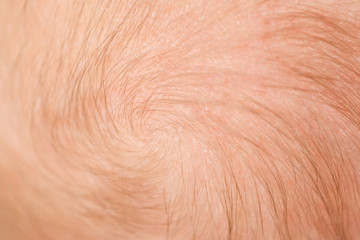 blond hair on the head of newborn