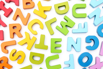 Rainbow Alphabet scattered on a white background