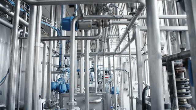 Stainless steel temperature control valves and pipes  in modern dairy