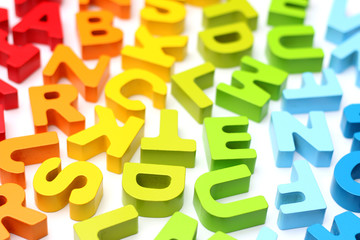 Rainbow Alphabet scattered on a white background