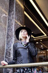 young pretty blond woman in stylish hat, street fashion