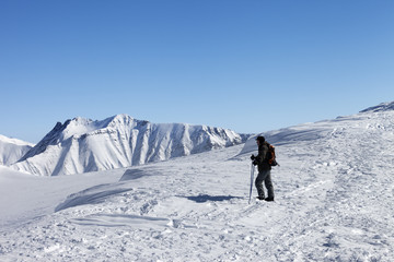 Fototapeta na wymiar Skier on top of ski slope at nice morning