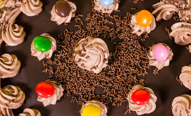 Tasty chocolate and hazelnut birthday cake colorful candy adorne