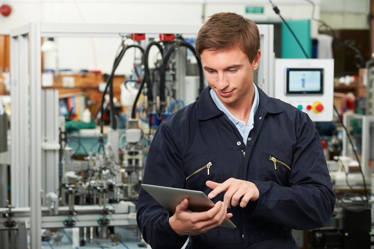 Engineer In Factory Using Digital Tablet