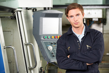 Portrait Of Engineer With Computer Controlled Cutting Machine