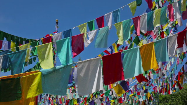 Buddhist prayer flags lungta (wind horses) against sky on kora around Tsuglagkhang complex. McLeod Ganj, Himachal Pradesh, India