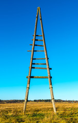 old triangel electricity wooden pole with blue sky