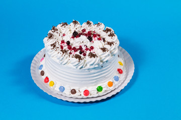 Tasty creamy birthday cake colorful candy adorned