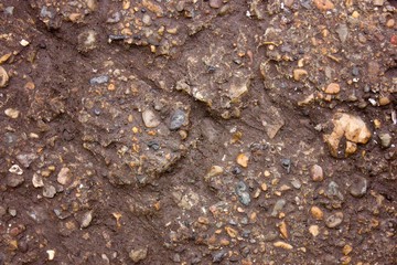 Brown old asphalt with stones texture background