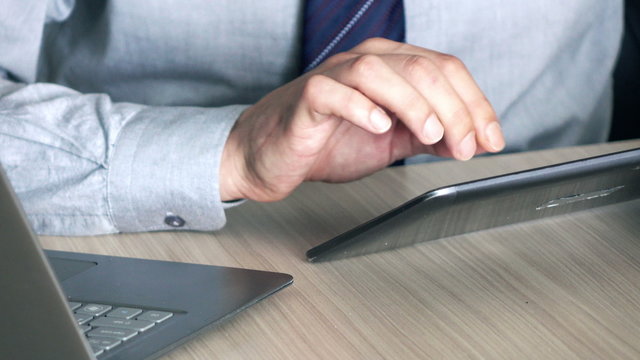 Businessman hands working on modern tablet in office 
