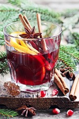 Mulled wine and spices on a rustic wooden table