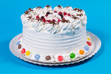 Tasty creamy birthday cake colorful candy adorned