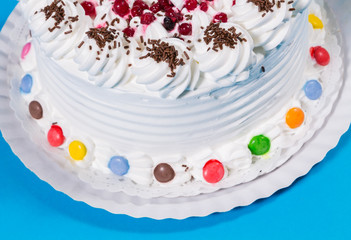 Tasty creamy birthday cake colorful candy adorned