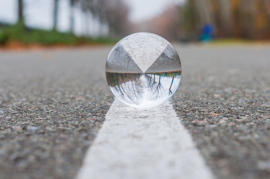 Glass Ball Or Orb For Fortunetelling, Soothsaying And Predicting The Future. On Textured Surface And White Line Background With Empty Space