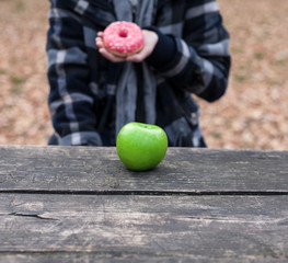 Unhealthy choice - doughnut over apple