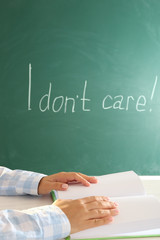 Women hands with book on blackboard background