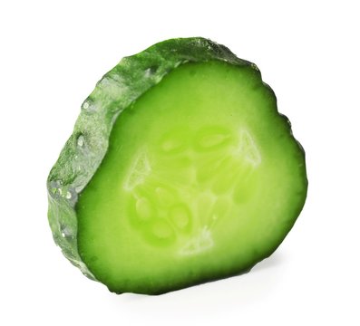 Slice of ripe cucumber isolated on white