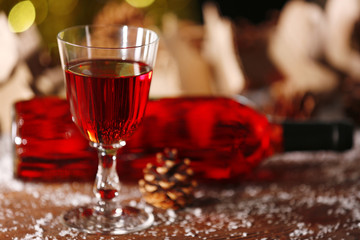 Wine glass and bottle on decorated wooden table