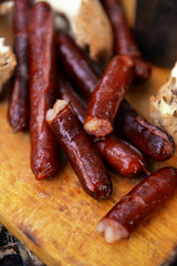 Grilled sausages on cutting board in the wood