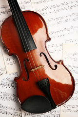 Fototapeta premium Violin on music papers background