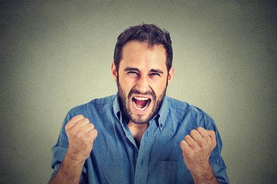 portrait of young angry man screaming