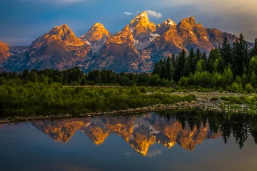 Wall murals Teton Range The dramatic colors of the Grand Teton Mountains reflecting in the water on a clear summer morning. 