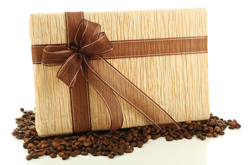 Beautiful gift with bow and coffee grains isolated on white