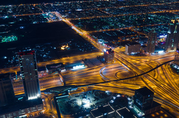 Fototapeta na wymiar downtown dubai futuristic city neon lights and sheik zayed road shot from the worlds tallest tower burj khalifa