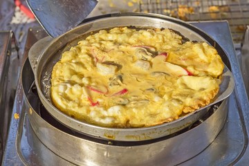 Oysters fried in egg batter on iron pan (cooking) - Thailand food
Pan-fried crispy mussel with bean sprout, Crisp fried oyster pancake - (Hoi Tod)
