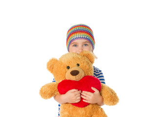 Little girl holding Teddy bear and heart.