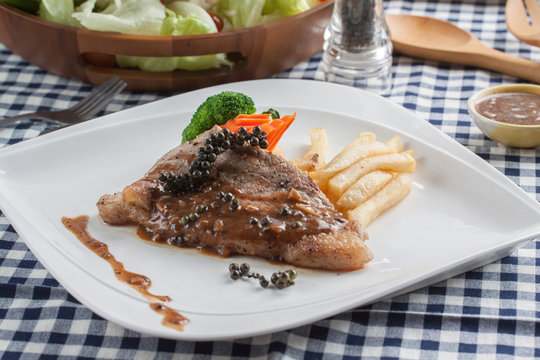 beefsteak with french fries and sauce on a plate