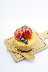 Isolated berries cheesecake on wood cutting board, berries sweet