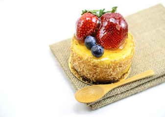 Isolated berries cheesecake on jute, berries sweet dessert on ju