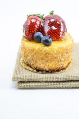 Isolated berries cheesecake on jute, berries sweet dessert on ju