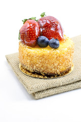 Isolated berries cheesecake on jute, berries sweet dessert on ju