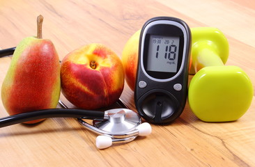 Glucose meter with medical stethoscope, fruits and dumbbells for using in fitness