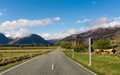 asphalt road through the field