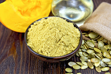 Flour pumpkin in bowl with oil and bag on board