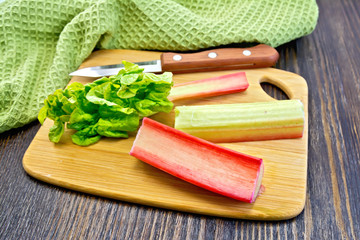 Rhubarb with knife and napkin on board