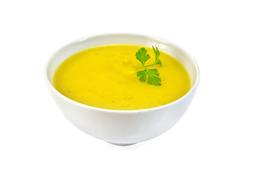 Soup-puree pumpkin with parsley in white bowl