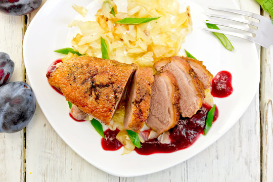 Duck breast with cabbage and green onions in plate