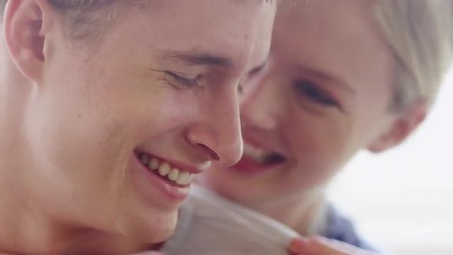 Closeup of young couple in love laughing and hugging