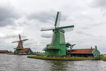 Fototapeta na wymiar Windmills and rural houses in Zaanse Schans near Amsterdam, Netherlands