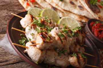 Delicious chicken tikka kebabs on skewers close-up. horizontal
